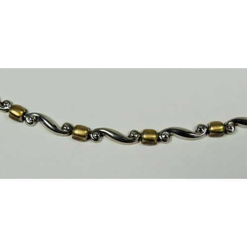 310 - 9ct Yellow and white gold necklace with serpentine and barrel links. 18 inches long.  10.8g