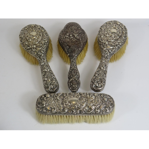 324 - 4 Sterling silver backed dressing table brushes all with hallmarks for Birmingham.