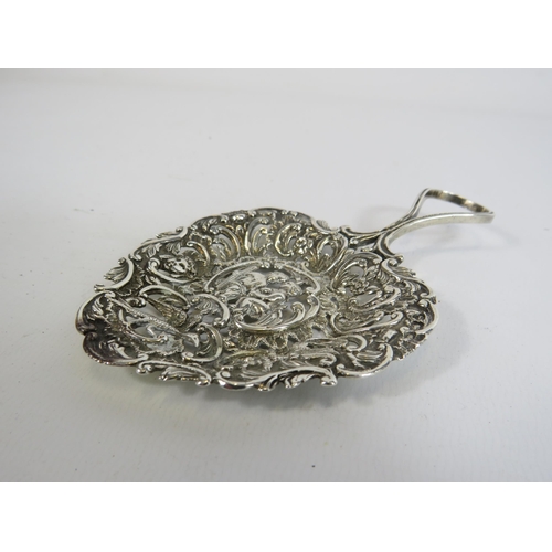 328 - Sterling silver short handled cake spoon decorated with cherubs. Hallmarked for London total weight ... 