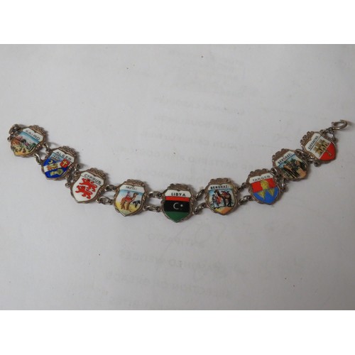 320 - 826  Sterling silver and enamel souvenir charm bracelet.