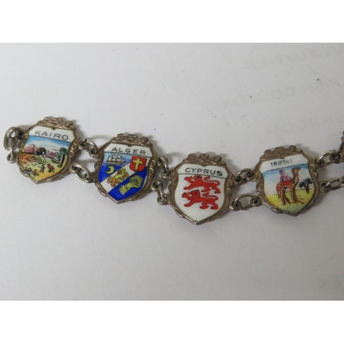 320 - 826  Sterling silver and enamel souvenir charm bracelet.