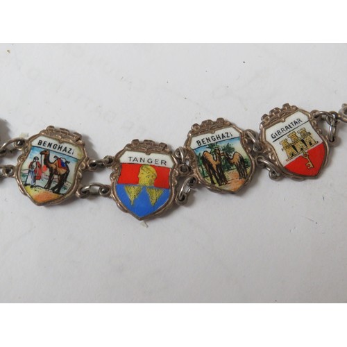 320 - 826  Sterling silver and enamel souvenir charm bracelet.