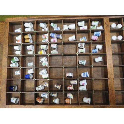 125 - Large wooden thimble display case and approx 100+ china thimbles all good names like Minton, Spode, ... 