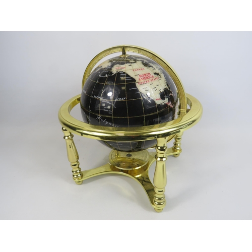 195 - Table top semi precious stone globe on a gold stand, approx 13