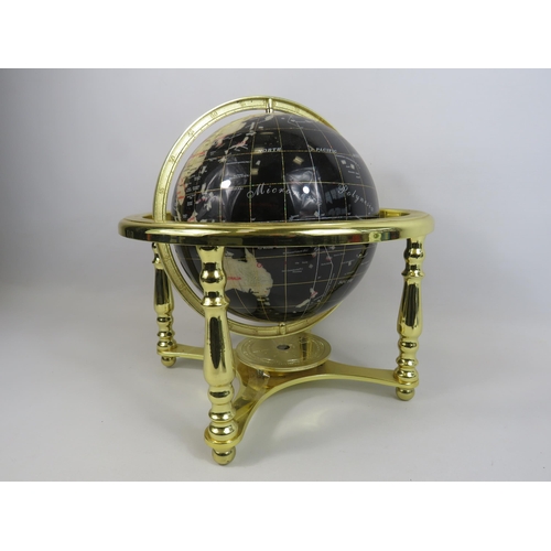 195 - Table top semi precious stone globe on a gold stand, approx 13