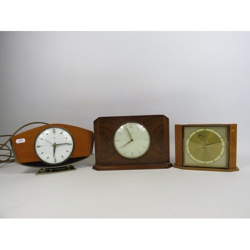 197 - A time savings coin operated clock and a German 8 day clock both in working condition plus a electri... 