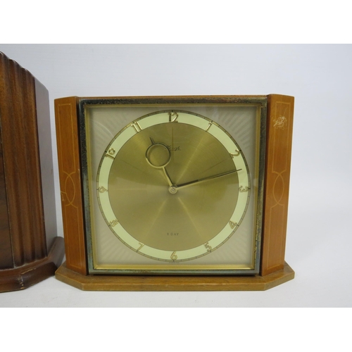 197 - A time savings coin operated clock and a German 8 day clock both in working condition plus a electri... 