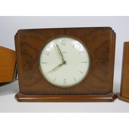 197 - A time savings coin operated clock and a German 8 day clock both in working condition plus a electri... 