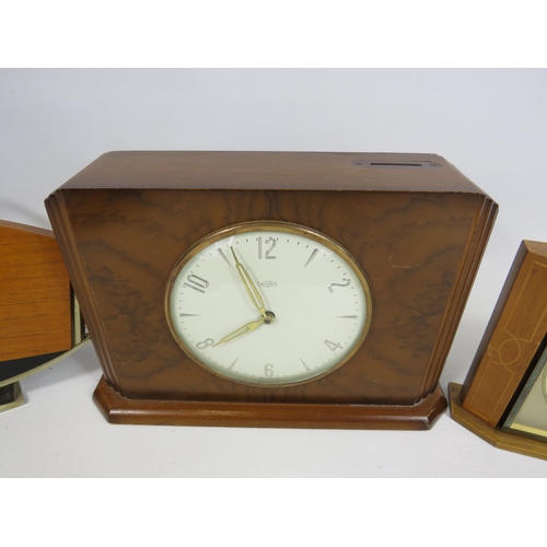 197 - A time savings coin operated clock and a German 8 day clock both in working condition plus a electri... 