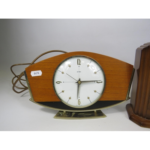 197 - A time savings coin operated clock and a German 8 day clock both in working condition plus a electri... 