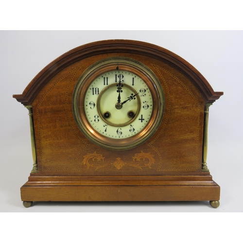 205 - French wooden mantle clock with enamel face and sitting on brass bun feet. In running order. 10 1/4