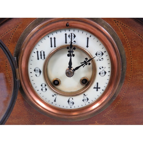 205 - French wooden mantle clock with enamel face and sitting on brass bun feet. In running order. 10 1/4