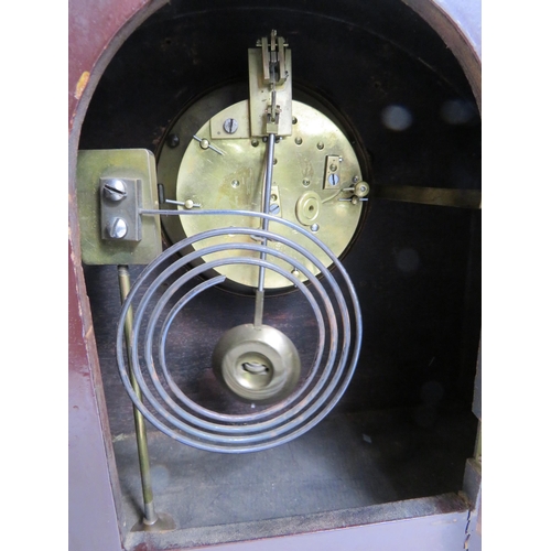 205 - French wooden mantle clock with enamel face and sitting on brass bun feet. In running order. 10 1/4