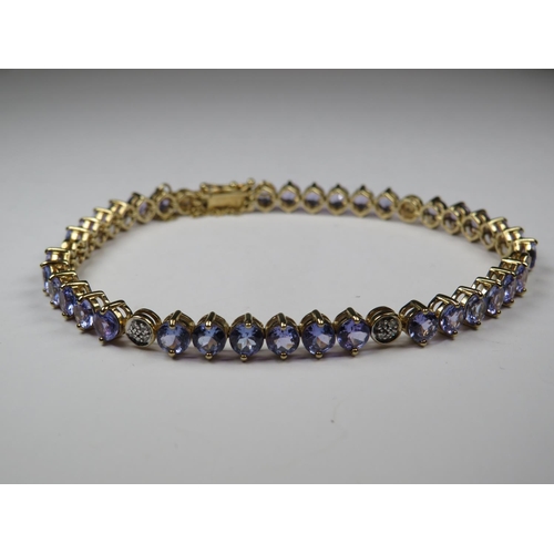 535 - Beautifully made 9ct Tanzanite bracelet interspersed with Diamond clusters. All set on 9ct Yellow go... 