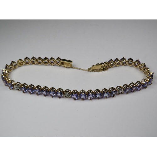 535 - Beautifully made 9ct Tanzanite bracelet interspersed with Diamond clusters. All set on 9ct Yellow go... 