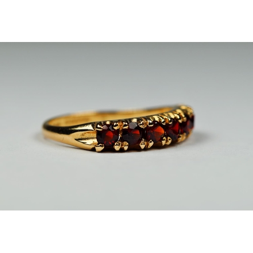 406 - 9ct Yellow Gold Garnet set quarter eternity ring. Finger size 'M-5'   2.1g.