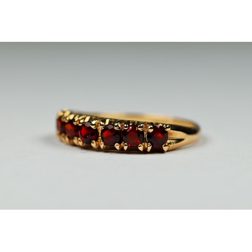 406 - 9ct Yellow Gold Garnet set quarter eternity ring. Finger size 'M-5'   2.1g.