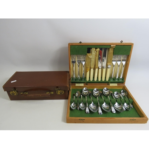 656 - Vintage cutlery set and a small vintage leather vanity suitcase.