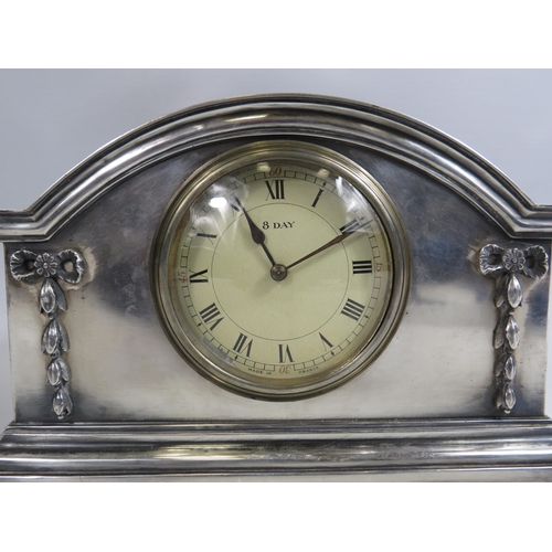 679 - Vintage French silverplated mantle clock which sits on bun feet. 6 1/4