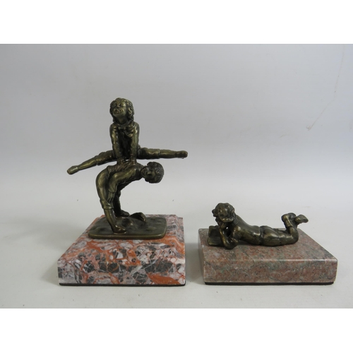 690 - 2 Small bronze effect sculptures of children on marble bases. The tallests is 6.5