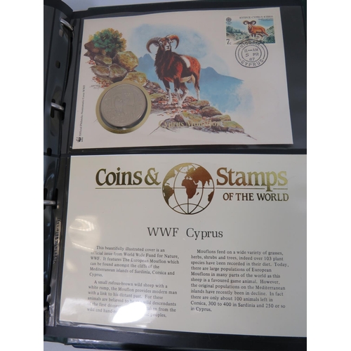 554 - Two well presented albums of Coins and stamps of the world.  See photos.