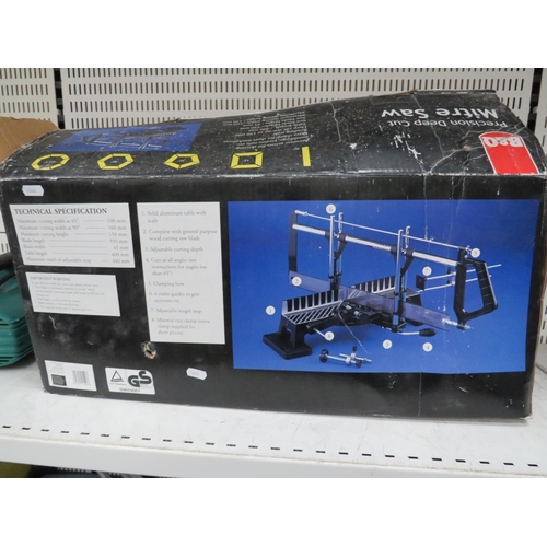 1064 - Bosch electric chain saw. Working condition unknown plus a B&Q mitre saw kit in box. See photos.