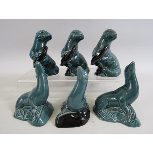 46 - 3 Poole pottery otters and 3 seals.