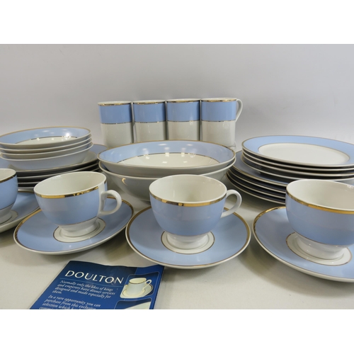 52 - Royal Doulton dinner set in blue, gold and white. Appears to be unsed, 30 pieces in total.