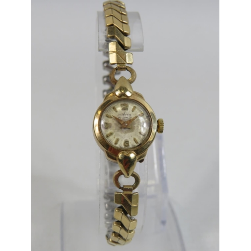 402 - Avia, 15 Jewel ladies  watch with yellow metal expanding strap.  9ct case. Running order. See photos... 