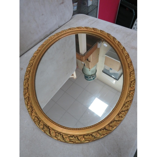 995 - Oval gilt framed mirror. 26.5