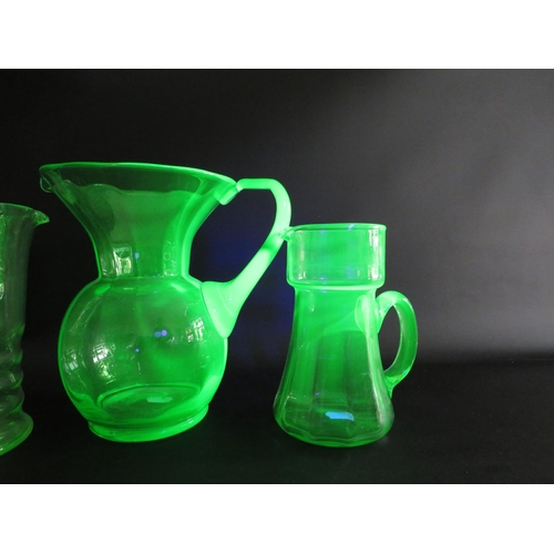 72 - 3 large Uranium glass jugs the tallest measures 22cm tall.