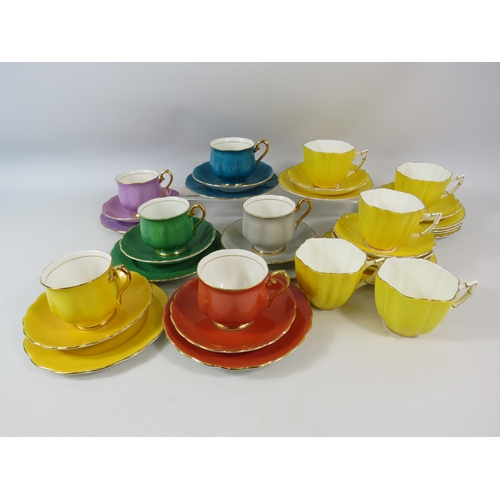 77 - Harlequin art deco china trios plus a set of vintage yellow cups and saucers.