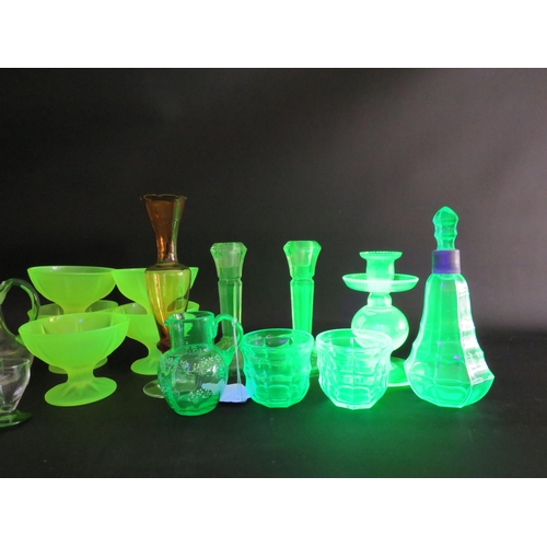 82 - Large selection of various coloured uranium glass, bottles, jugs, candlesticks, bowls etc.