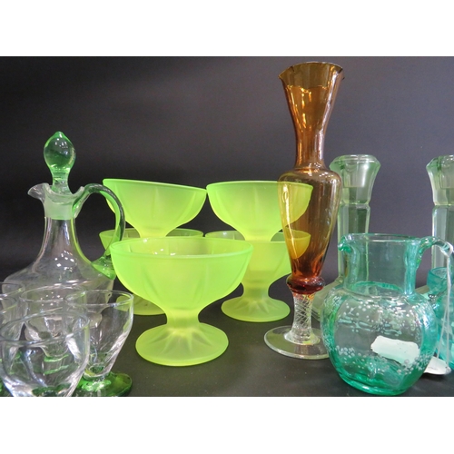 82 - Large selection of various coloured uranium glass, bottles, jugs, candlesticks, bowls etc.