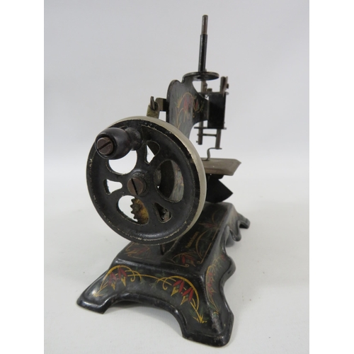 141 - Vintage German tin plate toy sewing machine.