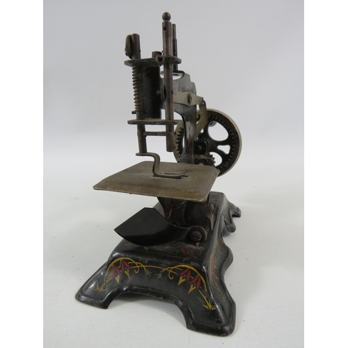 141 - Vintage German tin plate toy sewing machine.