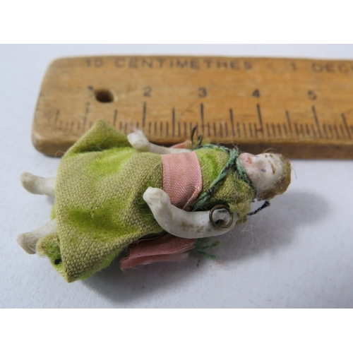 516 - Antique Miniature porcelain doll, 4cm long.