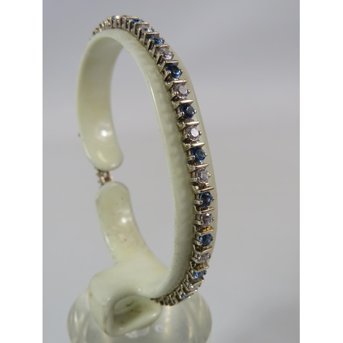 520 - 925 silver tennis bracelet with blue and clear stones.