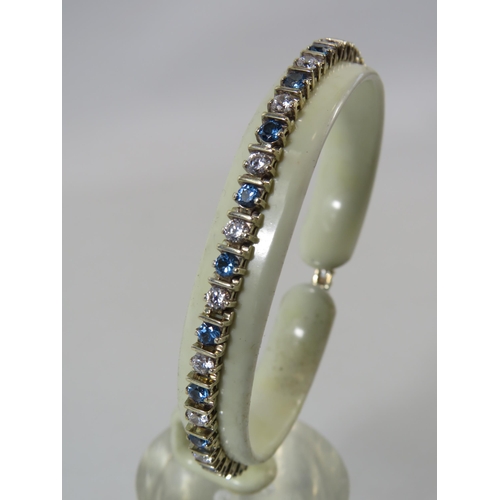 520 - 925 silver tennis bracelet with blue and clear stones.