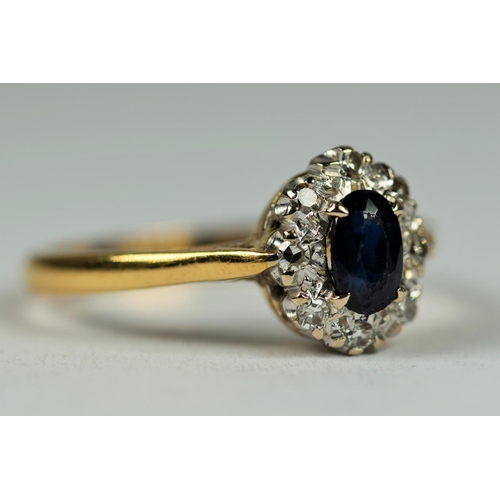 431 - 18ct Yellow Gold ring set with a Central Oval Sapphire with Diamond Halo.  Finger size M  3.1g