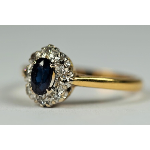 431 - 18ct Yellow Gold ring set with a Central Oval Sapphire with Diamond Halo.  Finger size M  3.1g