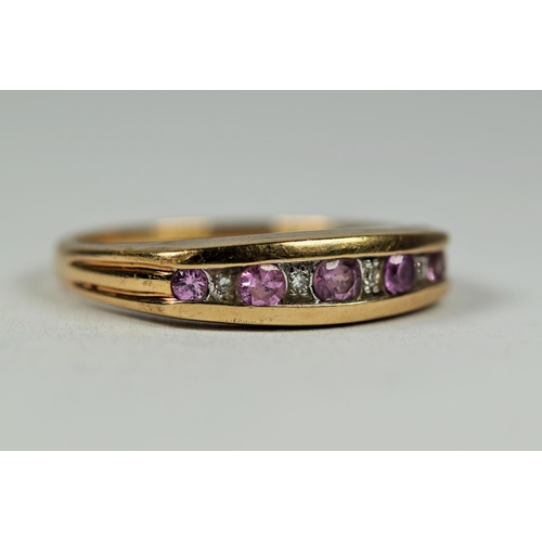 448 - 9ct Yellow Gold ring set with Pink and clear Diamonds in an oval trench setting.   Finger size Q    ... 