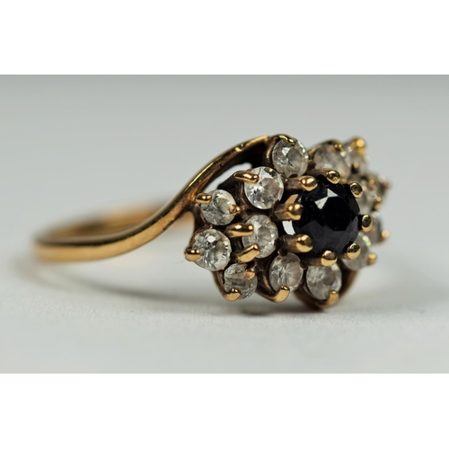 474 - 9ct Yellow Gold ring set with a central Sapphire with CZ cluster surround.    Finger size       2.7g