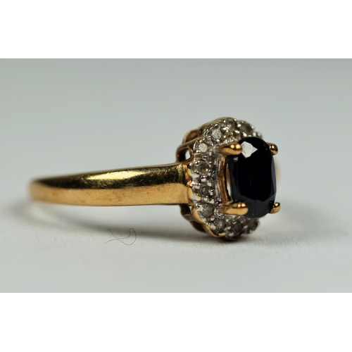 475 - 9ct Yellow Gold ring set with an Oval Central Sapphire with Diamond Surround.  Finger size         1... 