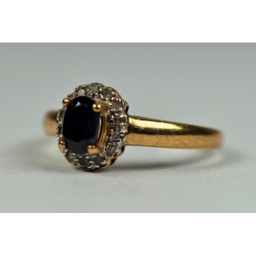 475 - 9ct Yellow Gold ring set with an Oval Central Sapphire with Diamond Surround.  Finger size         1... 