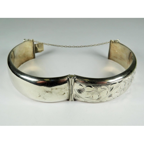 537 - Hallmarked Silver Bangle Bracelet with safety chain fitted in good order.  Chased decoration. Excell... 