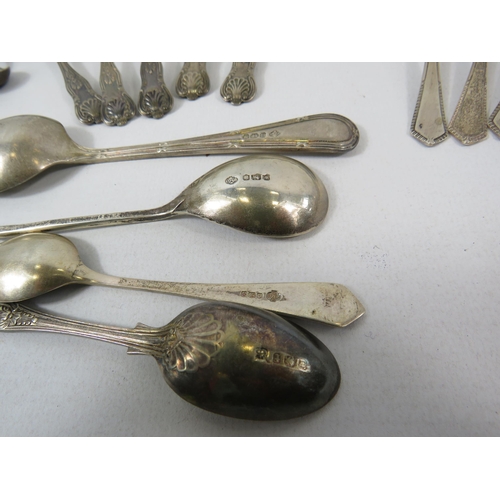 561 - 370 grams of Hallmarked sterling silver spoons and sugar tongs.