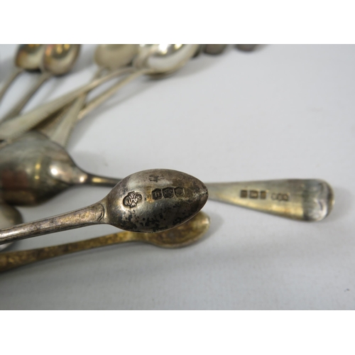 561 - 370 grams of Hallmarked sterling silver spoons and sugar tongs.