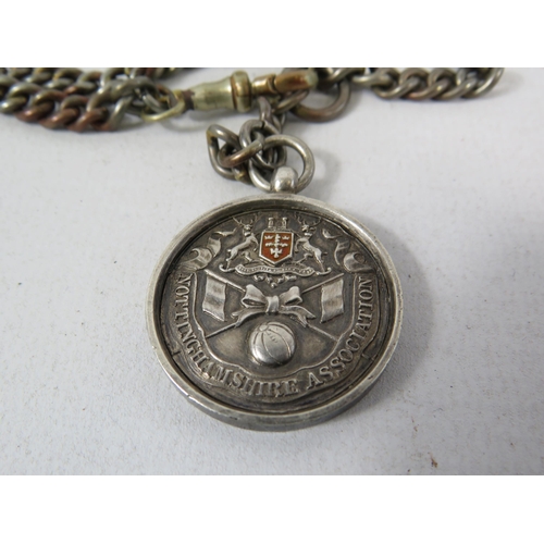 575 - Nottingham Association 1911 Sterling silver fob with a white metal chain.