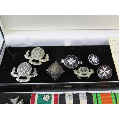 586 - Selection of St Johns Ambulance badges, pips and a sterling silver necklace and pendant.